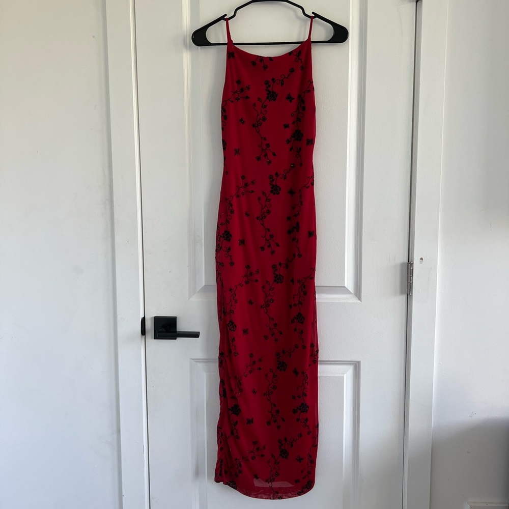 A red dress with black sparkly flowers from City Triangle in perfect condition.